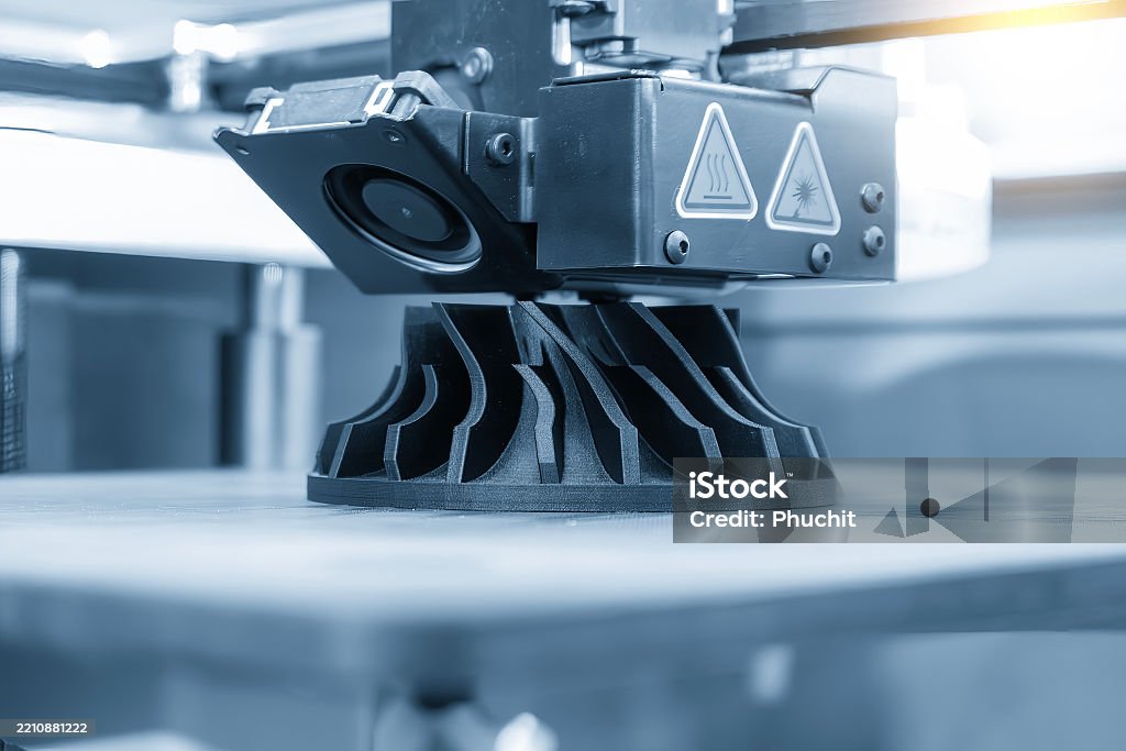 Close up scene the additive manufacturing by 3D printer machine in the light blue scene. The high technology manufacturing process by rapid prototype method.